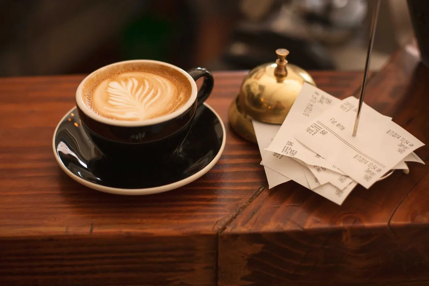 Latte with foam art on a wooden bar
