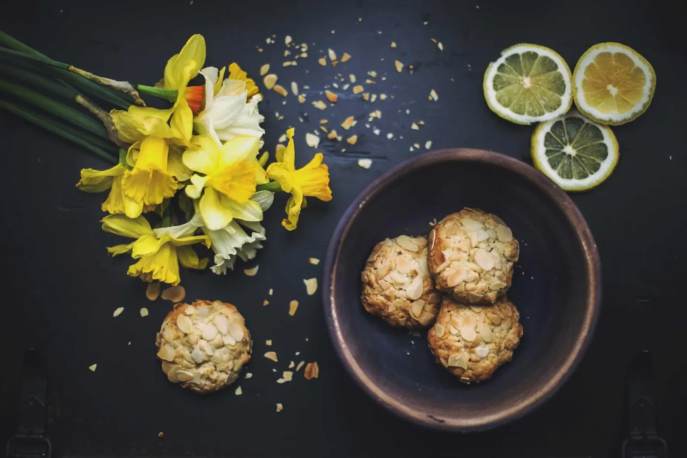 Sharing plates of cookies, citrus and flowers