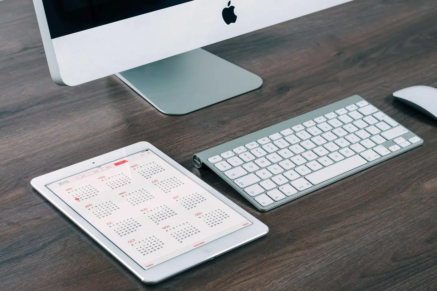 Desktop computer, tablet and keyboard on a clean desk