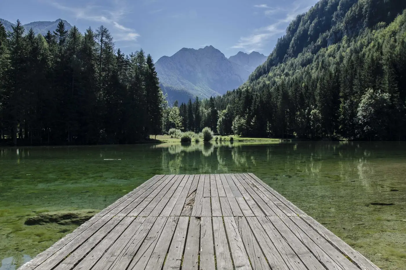 Wooden pier on a clear mountain lake