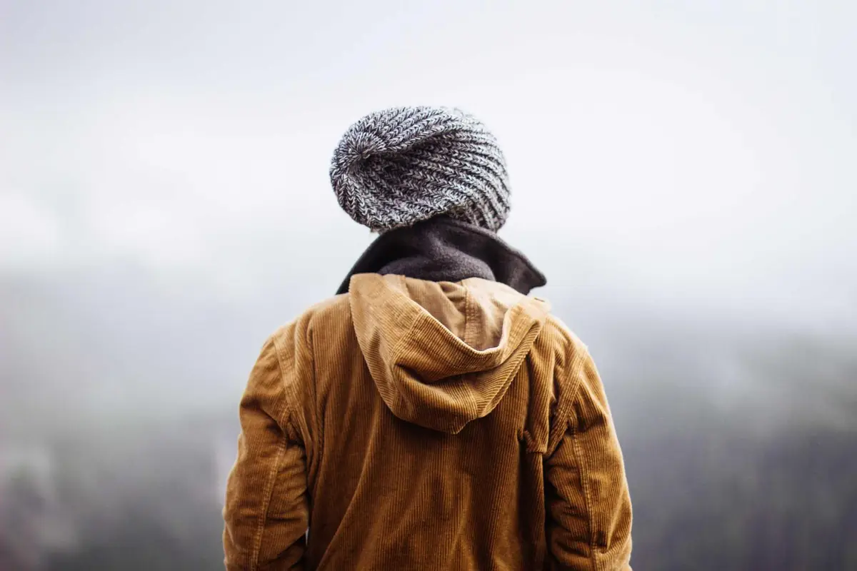 Traveller in a yellow jacket looking at the view